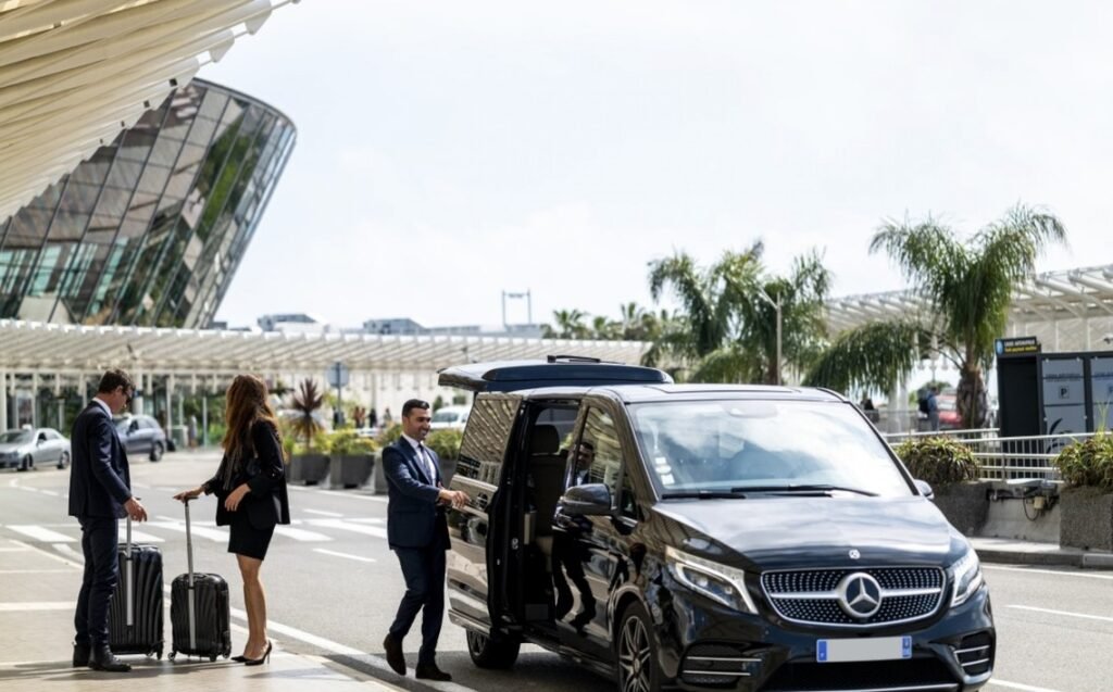 The personalized options for private transfers and tours in NYC 31 Private airport transfer service with a luxury Mercedes-Benz van, chauffeur assisting business travelers with luggage.