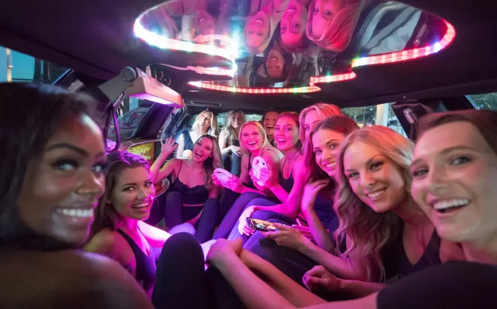 Customizing Your Party Limo Experience with Music, Drinks, and Decorations in New York City 31 Group of women celebrating in a limo with LED lights, smiling and enjoying a fun party night in New York City.