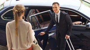 Professional chauffeur with luxury black car offering private car service in a modern city environment.